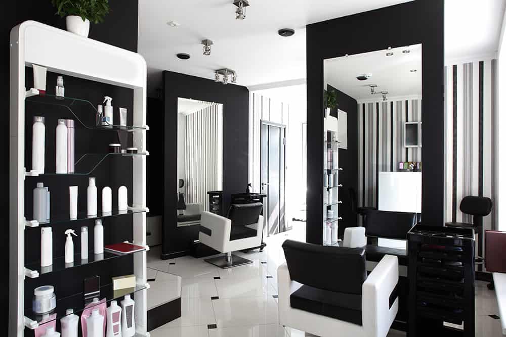 Interior of a hair salon with a black and white theme.